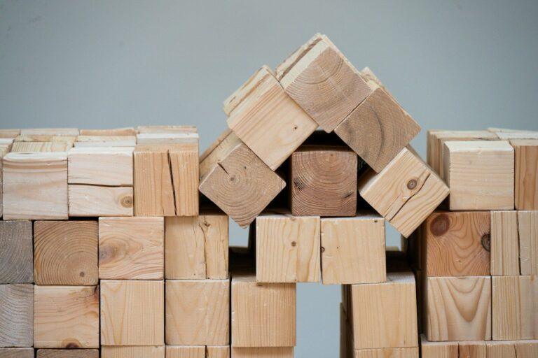 A structure made of wooden blocks resembling a house